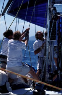 Crew hoist the heavy sails on a Maxi