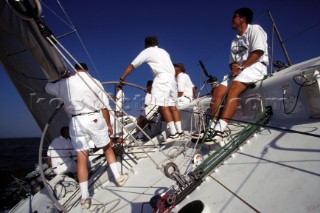 Rear view of crew at the helm of a racing yacht