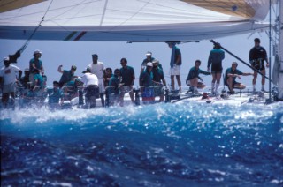 Wave about to hit the leward side of a racing yacht