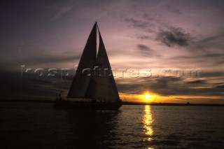 Sailing yacht in the sunset or sunrise