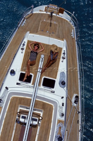 Two women sunbathe on the deck of a Swan 55 in the Caribbean
