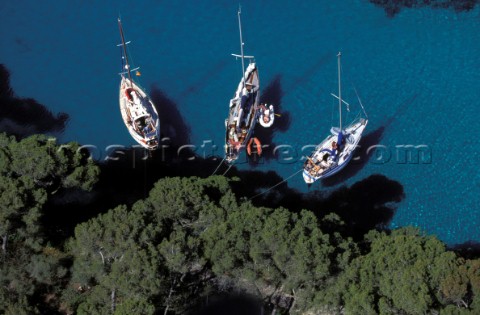 Three yachts anchored in sheltered water  Mallorca
