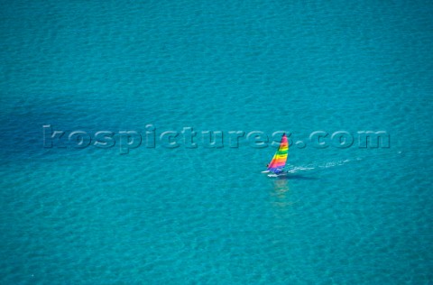 Ariel shot of a dinghy in crystal clear shallow water