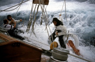 Crew members get a soaking as they hang on to the rail on the side deck of classic yacht Astra