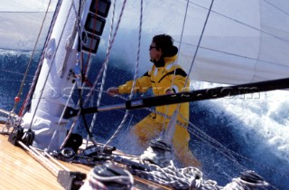Crew member on side deck of Swan yacht in rough seas