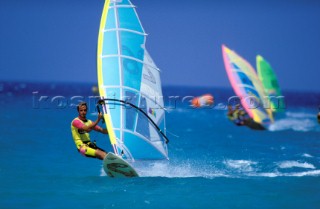Windsurfers racing in windy conditions
