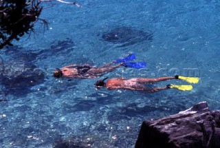 Two women snorkelling in shallow water