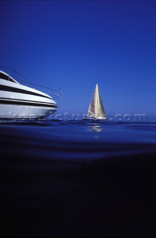 Power boat and sailing yacht in a calm sea  Mediterranean