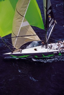 IACC boat Auckland New Zealand. Crew prepare to drop green spinnaker.