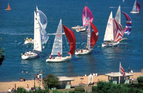 Fleet IRC passing The Green and beach durng Cowes Week