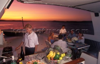 Evening BBQ aboard a superyacht with crew cooking the food