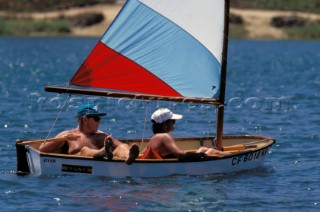 Couple realxing on a wooden dinghy