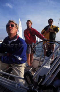 Helmsman and two crew on board Swan 51 Formosa during The Round the Island Race, Solent, UK