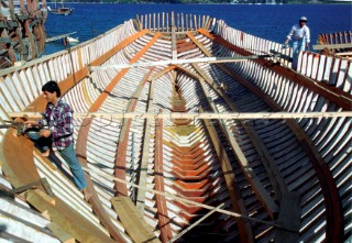 Boat builders construct the hull of a wooden ship in Caicchi Shipyard, Turkey