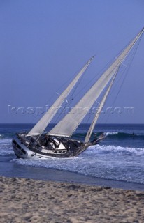 Sailing yacht Priority beached at low tide in California