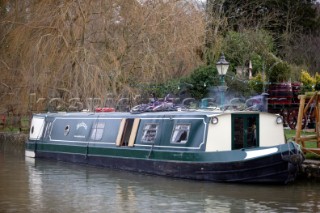 Canal boat moored outside public house (pub).  Canal boats on English Kennet and Avon Canals.
