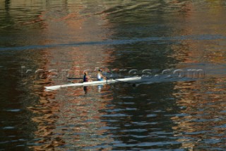 Two women in a Rowing scull on the River Thames.  Rowing pair.