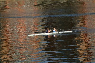 Two women in a Rowing scull on the River Thames.  Rowing pair.