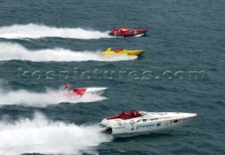 18/6/04 Fiumicino, Rome Italy. The fleet start in rough seas off the town of Fiumicino, already the lead boats in the championship Thuraya in red top of picture and Fainplast in the Supersport class (boat nearest) take the lead at the start.