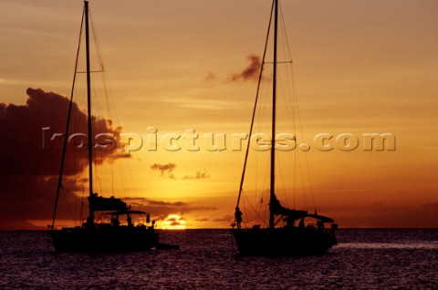 Two anchored yachts at sunset