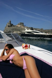 A glamorous model onboard a luxurious powerboat in the Mediterranean