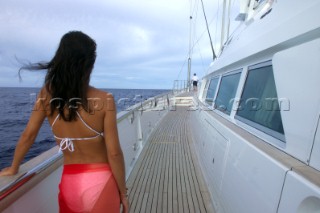 Girl in bikini on side deck of superyacht