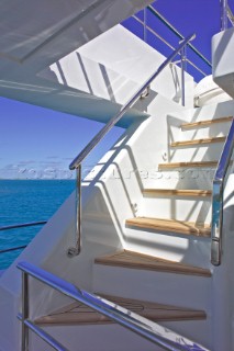 Graphic flight of stairs and stairway on a motor superyacht in the turquoise water of the Caribbean