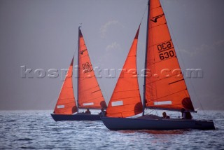 Dinghies and dayboats with orange sails