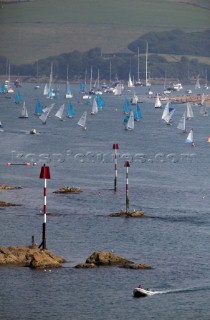 Enterprise and laser dinghies racing by rocks and navigational marks during Salcombe week