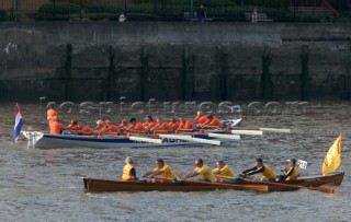 Rowing boats from around Europe compete in the Great River Race down the Thames in London, UK