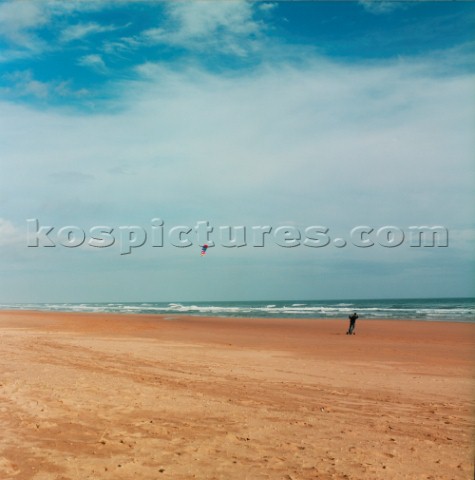 Man kite boarding on flat sandy beach near Aberdeen Scotland