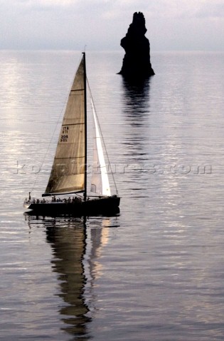 ATALANTA II sails passed Filicudi Island during the Rolex Middle Sea Race 2005