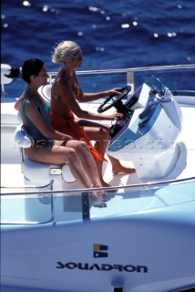Male and female models relaxing and socialising on a luxury Fairline powerboat