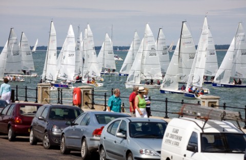COWES ENGLAND  JULY 29 Sailors in the 100 boat Laser SB3 Class short tack along the shoreline during