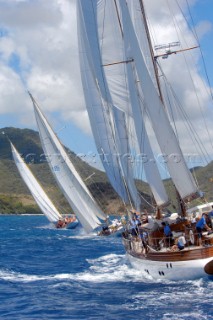 The chase is on for boats sailing in the Antigua Classic Yacht Regatta April 2006 on a sunny day with an island backdrop