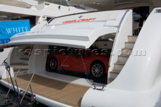 Red sports car in the stern garage of a superyacht