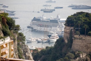 Mega yachts and superyachts moored in Monaco harbour, where cruise ships now also have berths