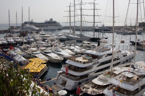 Mega yachts and superyachts moored in Monaco harbour where cruise ships now also have berths