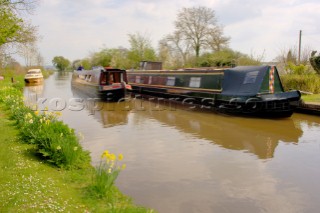 Narrow boat passing moorings on Llangollen canal near Frankton Junction,Welsh Frankton,Shropshire,England,UK.