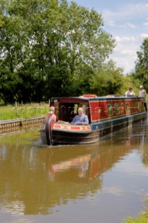 People on narrowboat approaching New Marton bottom lock,Llangollen canal,New Marton,Shropshire,England.June 2006.
