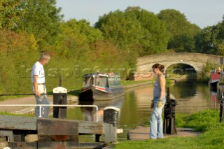 Couple on narrowboat about to operate the lock at Wheaton Aston on the Shropshire Union canal,Staffordshire,England,September 2006.