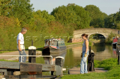 Couple on narrowboat about to operate the lock at Wheaton Aston on the Shropshire Union canalStaffor