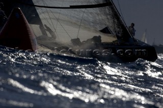 silhouette of a bowman and AC yacht