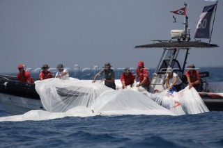 Valencia (Spain) Areva Challenge lose gennaker and spinnaker in the water after a chase boat drop. The sail is recovered by its support boat RIB.