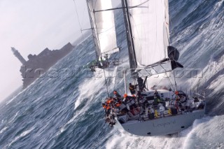 The super maxi Rambler racing around the Fastnet Rock Lighthouse chased by ICAP Leopard during the Rolex Fastnet Race 2007 (Editorial Use only)