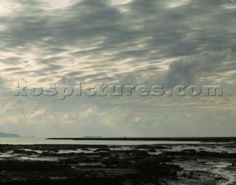 A backlit sky full of grey clouds makes for a moody scene in the Western Solent viewed here from Tan