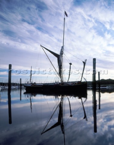 Early morning with a totally calm Beaulieu River at Bucklers Hard Hampshire The barge Victor moored 