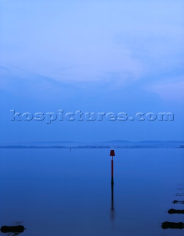 Subdued colours post sunset on a very calm Solent looking across from Pennington Marshes to Yarmouth