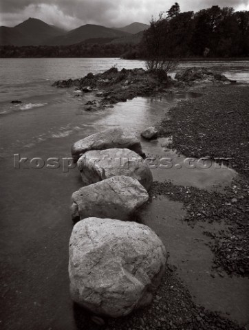 Four large foreground boulders on the eastern shore of Derwent water in the Lake District with shimm
