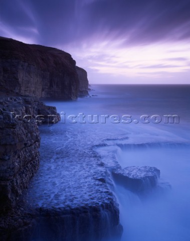 Blue light appears to pour through the water in this picture giving the Jurassic cliffs at Dancing L